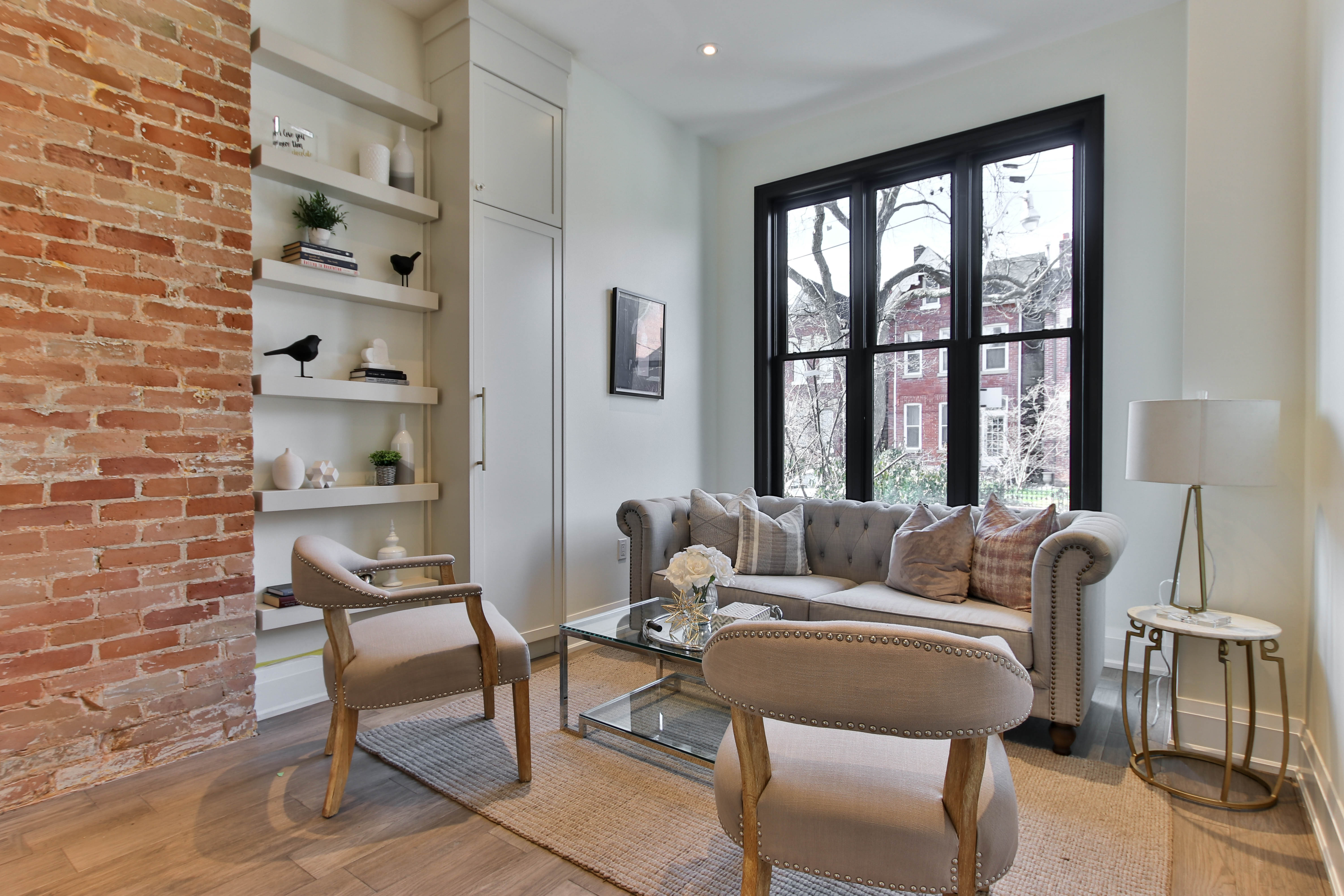 Interior living room with warm natural light, sofa, and built-in shelving.